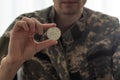 Gold bitcoin and soldier in military uniform