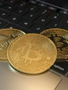 Gold Bitcoin virtual money close-up, keyboard background