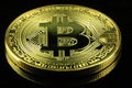 Gold Bitcoins cryptocurrency money on a black background