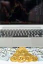 Bitcoins and dollar bills appearing from above the laptop Royalty Free Stock Photo