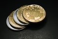 Bitcoin. Gold Bitcoins on a one hundred dollar bill close up Royalty Free Stock Photo