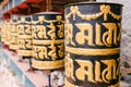 gold and black religious prayer wheels in Bhutan