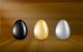 Gold, Black and Silver Eggs Collection on Wooden Background Royalty Free Stock Photo