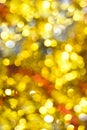Gold bokeh background. Texture with shining blurred lights in yellow, red and silver. Abstract Christmas festive background. Royalty Free Stock Photo
