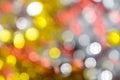 Gold bokeh background. Texture with shining blurred lights in yellow, red and silver. Abstract Christmas festive background. Royalty Free Stock Photo