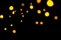 Gold bokeh on dark background. Defocused golden lights. New Year, Christmas background, abstract texture. Royalty Free Stock Photo