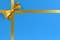 Gold bow gift ribbon blue background Royalty Free Stock Photo