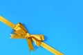 Gold bow gift ribbon corner diagonal blue background Royalty Free Stock Photo