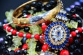 Gold bracelet and pendant with blue stones, coral beads against a dark background. Royalty Free Stock Photo