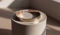 A gold bracelet is sitting on a white marble base Royalty Free Stock Photo