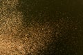 Gold and bronze glitter color confetti dots splash on black. Abstract glow shiny background Royalty Free Stock Photo