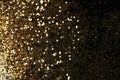 Gold bronze glitter shine dots confetti on black.  Abstract light blink sparkle horizontal background Royalty Free Stock Photo