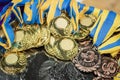 gold and bronze medals with yellow- blue ribbons on a silver tray, Champions awards, the third place prize for the winner, it is Royalty Free Stock Photo