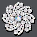 gold brooch flower in gems with pearls. Beautiful decoration with reflection Royalty Free Stock Photo