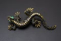 Gold brooch lizard with gems isolated on black Royalty Free Stock Photo