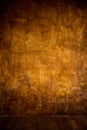 Gold brown background paper with vintage grunge background texture with black scuffed edges and old faded antique design has copy