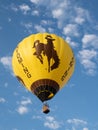 A Wyoming Hot Air Balloon with Bucking Bronco Flying at Big Sky Royalty Free Stock Photo