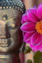 Gold buddha head statue and flower. Spiritual meditation and Zen buddhism nature image