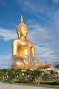 Gold buddha statue under construction in Thai temple with clear sky.WAT MUANG, Ang Thong, THAILAND. Royalty Free Stock Photo