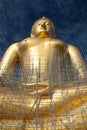 Gold buddha statue under construction in Thai temple with clear sky.WAT MUANG, Ang Thong, THAILAND. Royalty Free Stock Photo