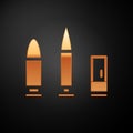 Gold Bullet and cartridge icon isolated on black background. Vector