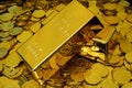 Gold bullion on pile golden coins