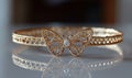Gold butterfly bracelet with diamond on reflective surface Royalty Free Stock Photo