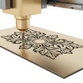 Gold C N C machine engraving floral pattern on metal plate Royalty Free Stock Photo