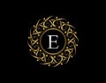 Gold Calligraphic Badge with Letter E Design. Ornamental luxury golden logo design vector illustration