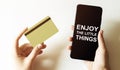 Gold card and phone with text disaster recover plan Enjoy the little things in the female hands Royalty Free Stock Photo