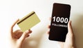 Gold card and phone with text disaster recover plan 1000 Followers in the female hands