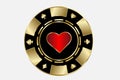 Gold casino chip with a bright red sign of the suit of hearts.