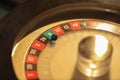 Gold casino theme. Image of casino roulette, poker games, money on the table, all on a dark bokeh background. Place for Royalty Free Stock Photo