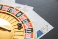 Gold casino theme. Image of casino roulette, poker games, money on the table, all on a dark bokeh background. Place for printing