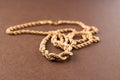 Gold chain on a brown background. Macro Royalty Free Stock Photo