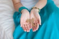 Gold chain in the hands of a young attractive oriental woman. Royalty Free Stock Photo