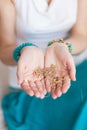 Gold chain in the hands of a young attractive oriental woman. Blurring background. Royalty Free Stock Photo