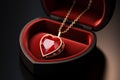 Gold chain with a heart-shaped ruby pendant in a festive jewelry box. Royalty Free Stock Photo