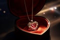 Gold chain with a heart-shaped ruby pendant in a festive jewelry box. Royalty Free Stock Photo