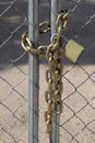 Gold Chain and Lock on chain link fence Royalty Free Stock Photo