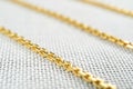 Gold chain necklaces over white sack background