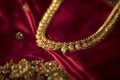 Gold chain placed on a red backdrop Royalty Free Stock Photo
