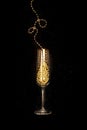 Gold champagne glass on black background, Christmas and New Year celebration Royalty Free Stock Photo