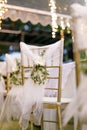 Gold chiavari chair decorate with a flower on a wedding day