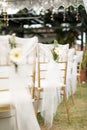 Gold chiavari chair decorate with a flower on a wedding day