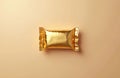 Gold chocolate bar on gray surface, rectangular shape, mocha brown color, single piece, centered, tilted corner, light beige Royalty Free Stock Photo