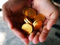 Gold chocolate coin in hand Royalty Free Stock Photo