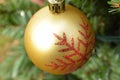 Gold Christmas ball ornament with red glitter snowflake design Royalty Free Stock Photo