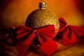 Gold Christmas ball with red bows