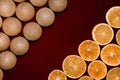 Gold christmas balls and dry orange slices on red velvet background Royalty Free Stock Photo
